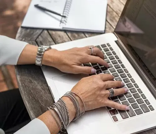man typing on gaming laptops for work
