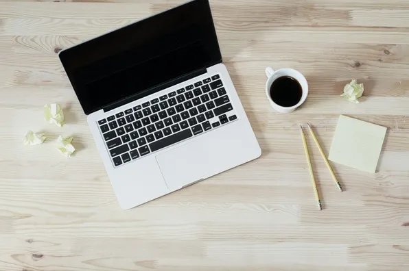 laptop remote work set up coffee table